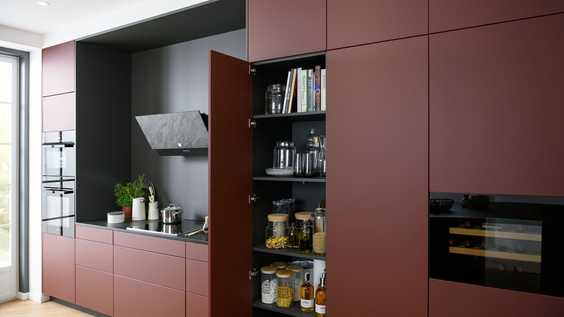 Large kitchen storage cupboards, matt red handleless front