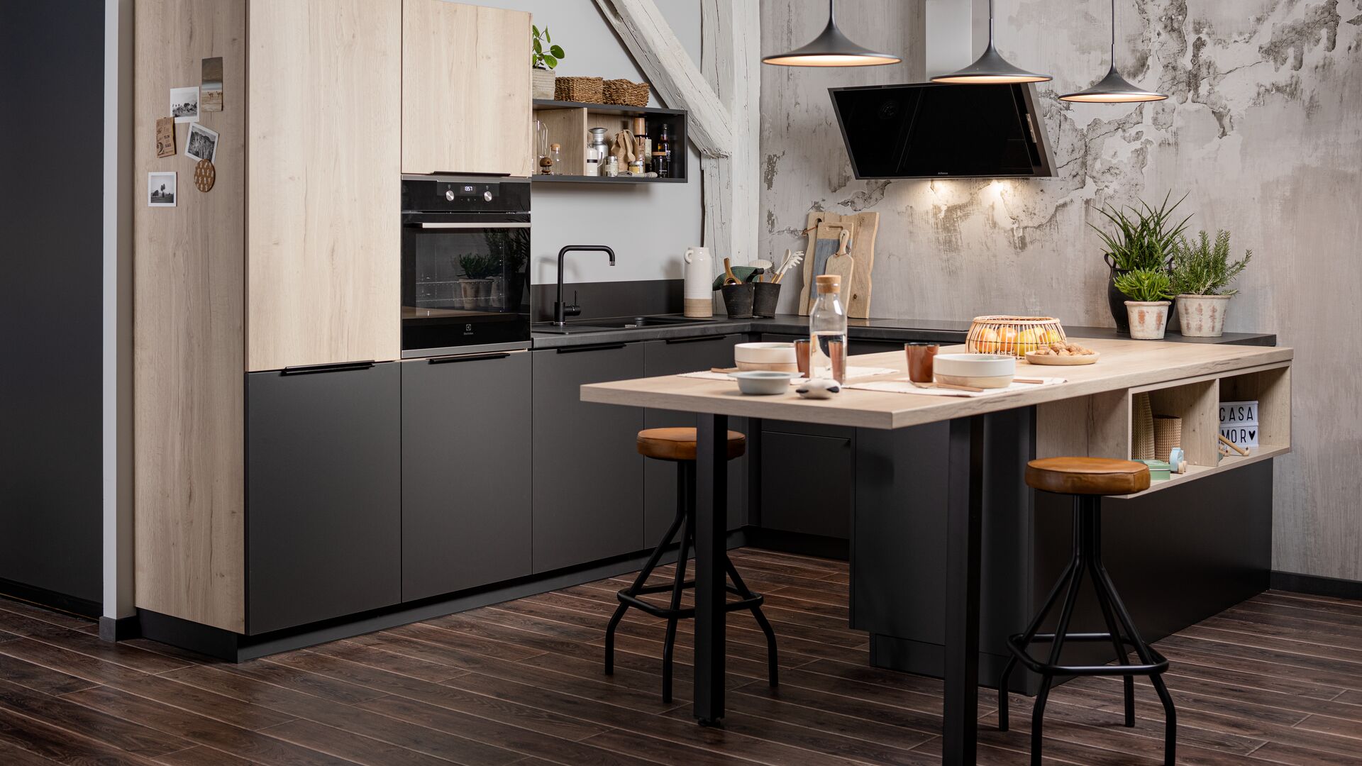 Small kitchen opening onto the lounge with an extended worktop island