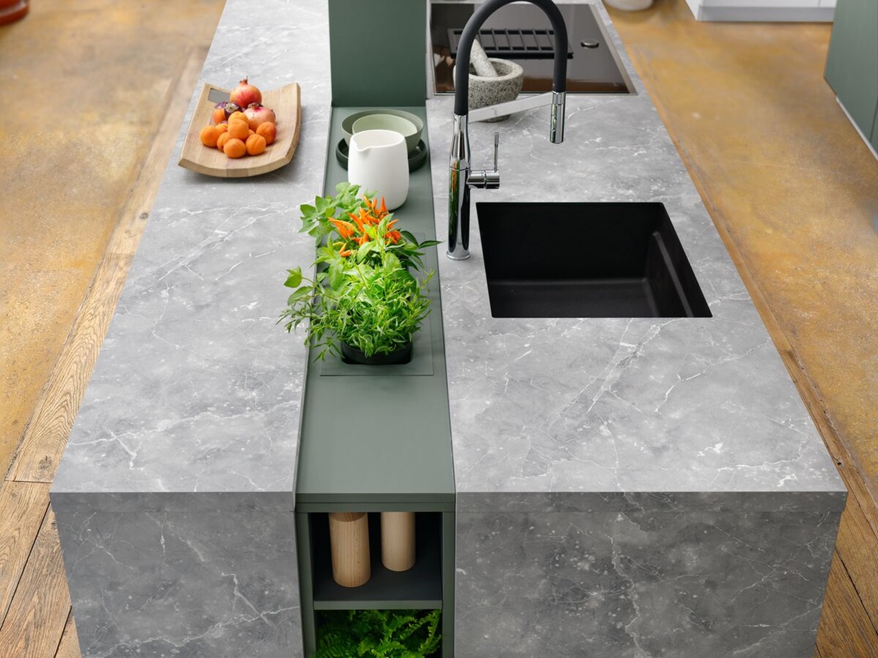 Kitchen island with concrete appearance and central planter