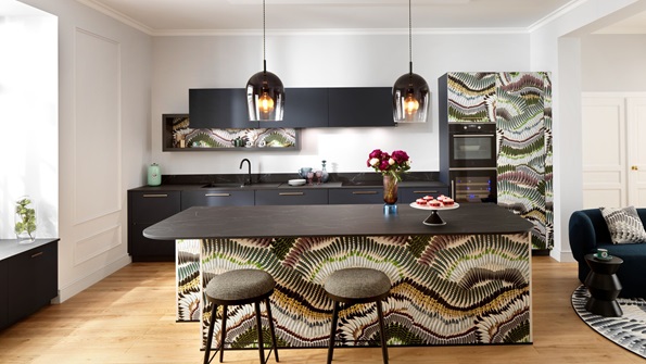 T-shaped kitchen island in black and terrazzo with a built-in dining table and cooking area